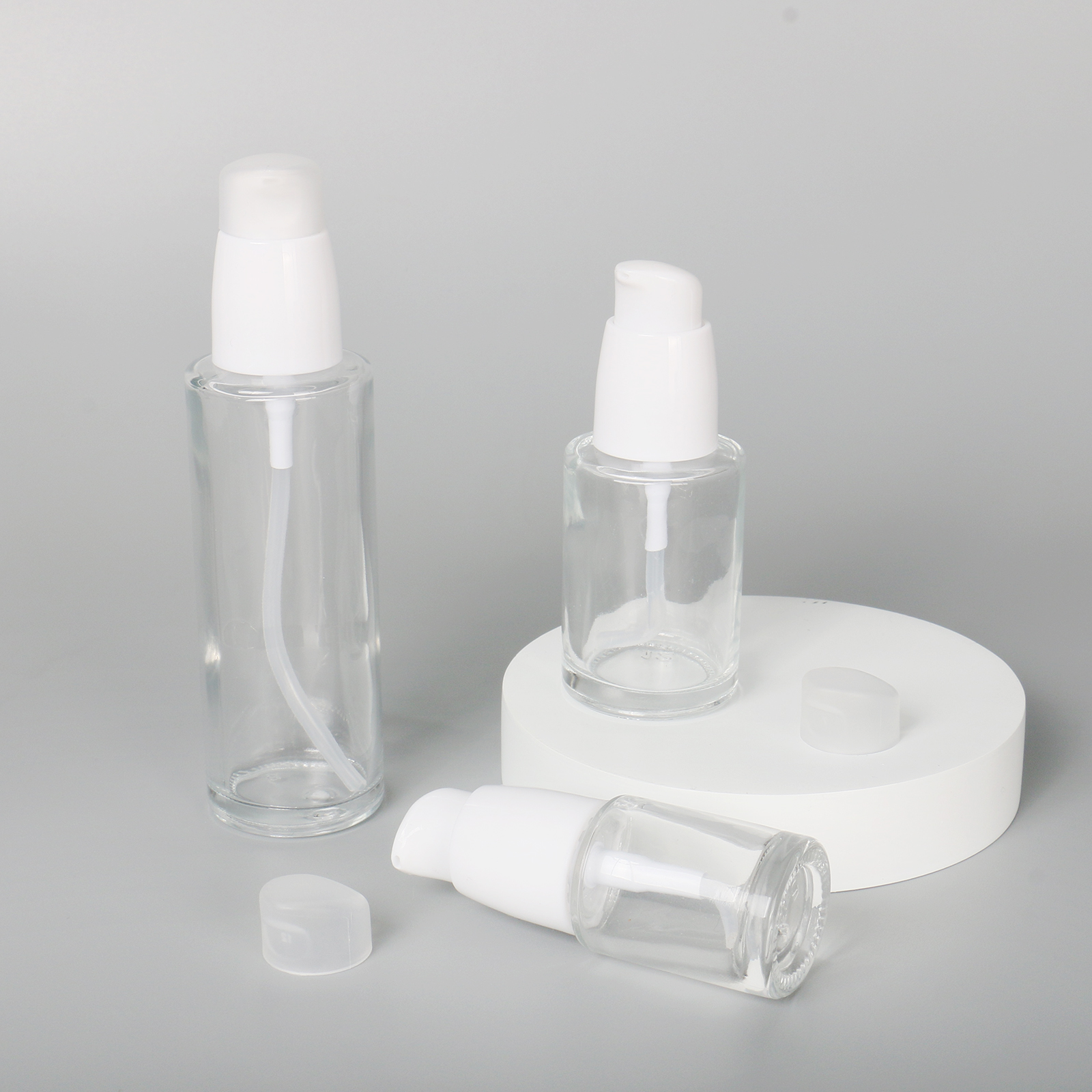 Eco Friendly 30ml 60ml 100ml Round Cosmetic Packaging Clear Empty Face Serum Pump Lotion Foundation Bottle Glass Serum Bottle With Pump