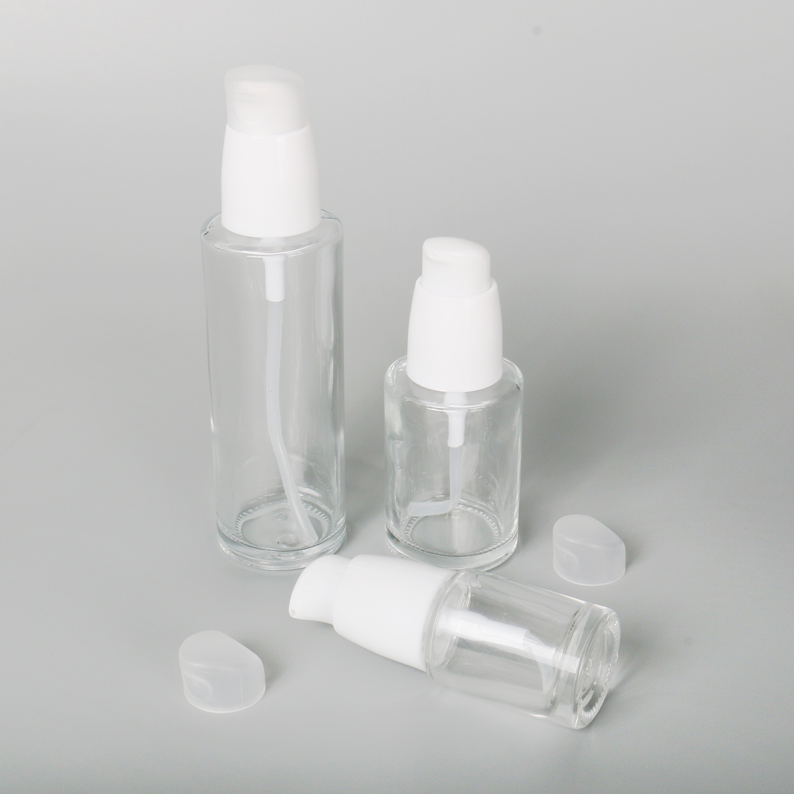 Eco Friendly 30ml 60ml 100ml Round Cosmetic Packaging Clear Empty Face Serum Pump Lotion Foundation Bottle Glass Serum Bottle With Pump