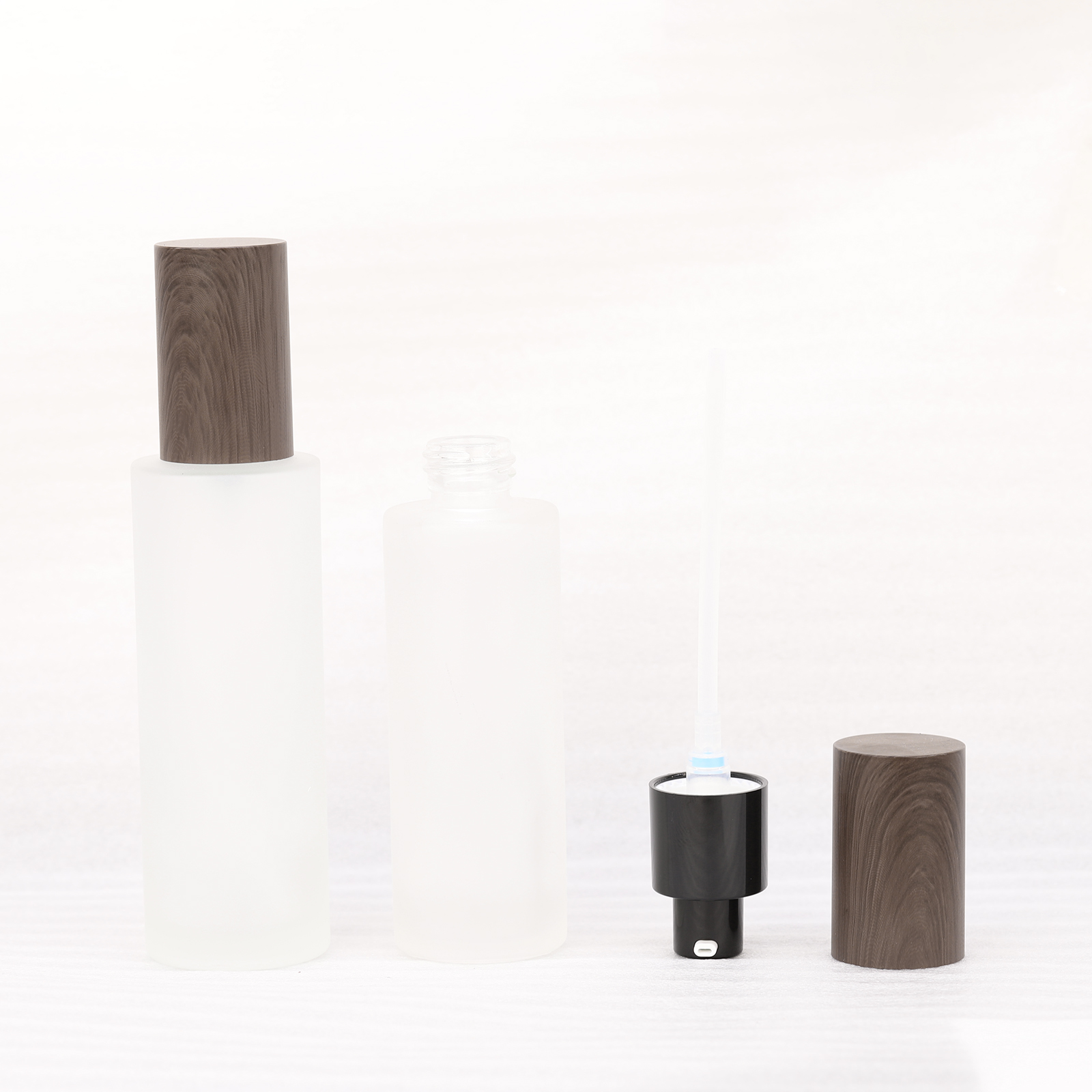 Cylinder Shaped Cosmetics Transparent Frosted Glass Press Lotion Sprayer Pump Bottle With Brown Wood Grain Lid